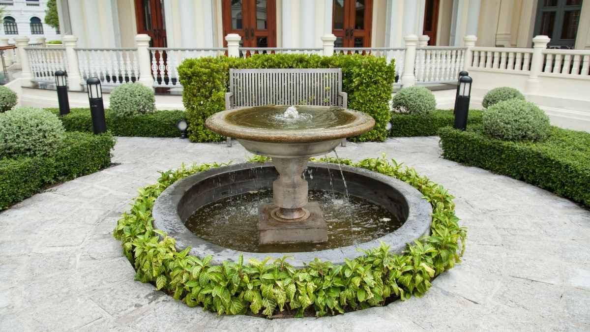pool in the garden. A bench in the rear of the corridor.